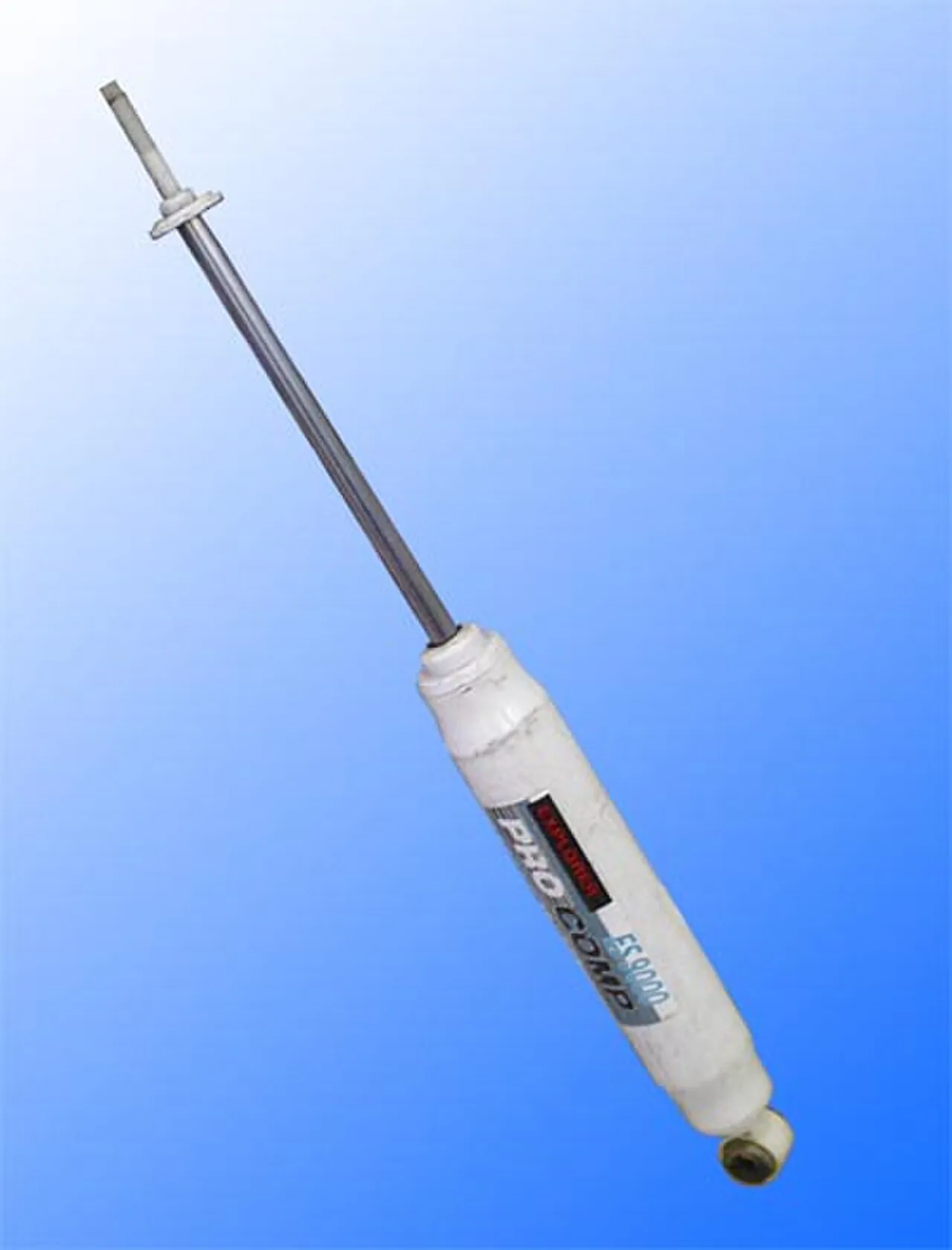 A telescopic hydraulic automotive shock absorber shown in isolation, with the piston rod and upper mount extended from the cylindrical damper body