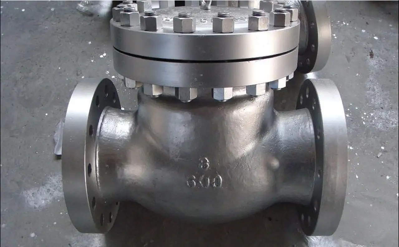 Cast stainless steel flanged swing check valve with a bolted bonnet on top, Class 600 3-inch size markings cast into the body